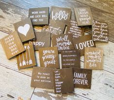 wooden coasters with handwritten words on them sitting on top of a wood floor