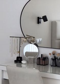 a white desk topped with a mirror and lots of makeup