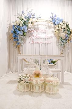 a white table topped with cakes and flowers