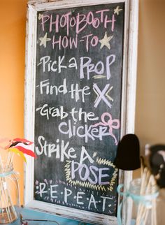 a chalk board with writing on it in front of a kitchen counter and utensils