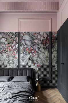 a bedroom decorated in pink and black with floral wallpaper on the walls, along with a bed