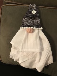 a black and white knitted hat sitting on top of a blanket