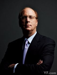 a man in a suit and tie is posing for a photo with his arms crossed