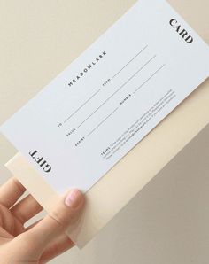 a person holding up a white card with black lettering