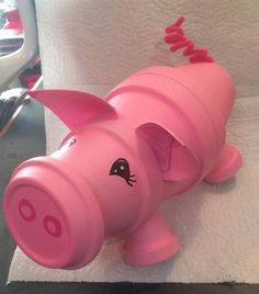 a pink pig toy sitting on top of a white towel