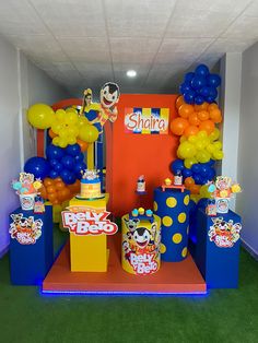 there are many balloons and decorations on display in this office space, as well as an entrance for the children's birthday party