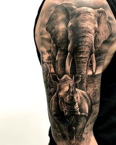 an elephant and zebra tattoo on the back of a man's arm