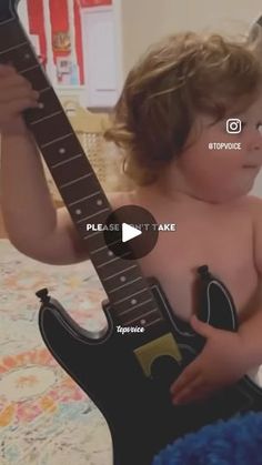 a young child is playing with a guitar