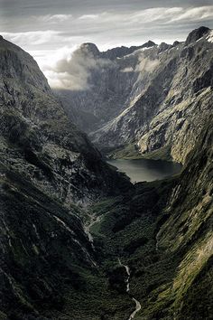 an aerial view of mountains and lakes in the middle of nowhere, with water running between them