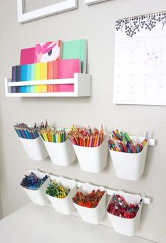 the wall is filled with different colored pencils and markers