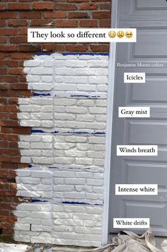 a brick wall that has been painted white with words on it and the names below