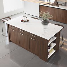 a large kitchen island with two stools in front of it and a potted plant on top