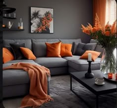 a living room filled with furniture and orange pillows