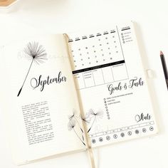 an open planner book sitting on top of a desk next to a cup of coffee