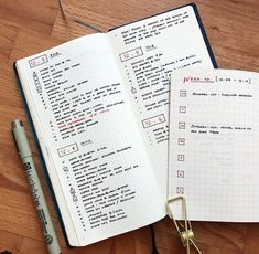 an open notebook sitting on top of a wooden table