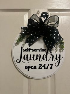 a sign that says self service laundry open 24 / 7 on the side of a door