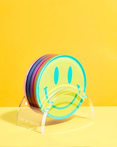 a stack of colorful plates sitting on top of a yellow table next to each other