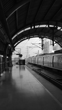 a black and white photo of a train station