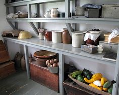 several shelves filled with different types of food and containers on top of each shelf in a room