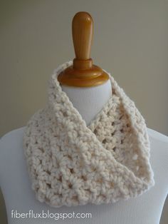 a white knitted scarf on top of a mannequin