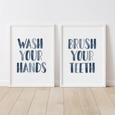 two framed posters with the words wash your hands and brush your teeth in blue ink