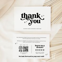 a thank card with the words thank you written in black ink on white paper next to a pile of matches