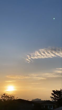 the sun is setting behind some clouds in the sky