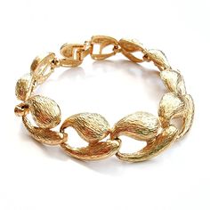 Gorgeous, chunky vintage chain bracelet in shiny, textured gold loops with a smart, secure clasp. This is a classic piece of jewellery adaptable to many different styles. Made in the 80's, it's been locked away for over 20 years in a disused factory, in England - awaiting its big come back! The factory produced high quality jewellery for England's fanciest names and department stores, starting with Selfridges, Harvey Nichols and Frank Usher. Metal. Made in England. The chain measures 1.5cm wide Chunky Gold Chain, Harvey Nichols, Chain Loop, Black Leather Wallet, Gold Bracelet Chain, Statement Bracelet, Gold Texture, New Vintage, High Quality Jewelry