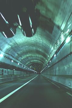 an image of a car going through a tunnel with lights on the ceiling and floor