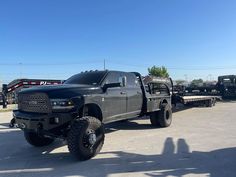 a large black truck parked in a parking lot