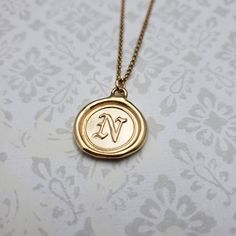 "Monogram Initial letter \"N\" Materials: Silver, Gold, Gold vermeil Gold vermeil is a thick 24k layer of gold over a solid sterling silver base. Size: Approx 3/4\" {21mm} The antique wax seals used to make my initials are mostly around 170 yrs but can be as young as 70 yrs, and as old as 750+ yrs old (My letter i). As each wax seal was individually collected, I am unable to change the font or size. They are only available as shown. PLEASE NOTE: Before you order please check sizing information - it can be hard to gauge jewelry sizes from pictures alone. On some of the seal pieces the text is so small as to be read only with a magnifying glass making the meaning a secret between you and those you choose to tell. Availability and shipping Your purchase will ship in 3-5 business days. Once sh Vintage Gold Initial Necklace As A Gift, Vintage Gold Initial Necklace For Gifts, Vintage Gold Initial Necklace For Gift, Gold Stamped Initial Pendant Charm Necklace, Gold Stamped Charm Necklaces For Anniversary, Gold Stamped Charm Necklace For Anniversary, Gold Engraved Medallion Initial Necklace, Gold Stamped Necklace For Anniversary, Gold Medallion Necklace With Stamped Detail