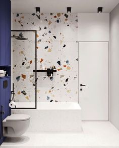 a bathroom with a toilet, sink and bathtub next to a wall mounted shower head