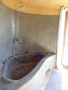 a large bathtub sitting inside of a bathroom next to a window