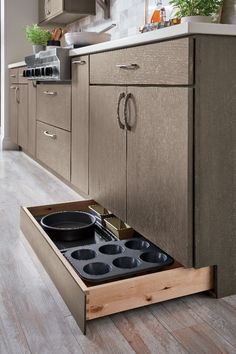 an open drawer in the middle of a kitchen