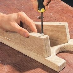 a person using a small tool on a piece of wood