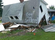 a house that has been torn down with the word got the spider written on it