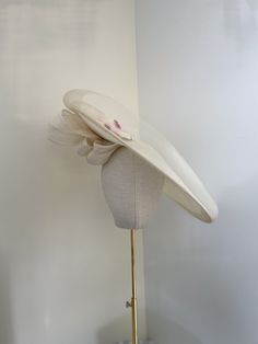 A Sinamay hand made ivory saucer hat. Mounted on to a matching head band. The headband can be changed to co ordinate your outfit. The hat is decorated on the top side with silk flowers. Finished with a large pleated silk abaca bow to the underside. The head band. The hat can be worn on the left or right hand side.  The saucer has a diameter of approx 47cm. - Not for the faint hearted, but looks absolutely stunning on. A real show stopper. This style can be made in various colours. White Formal Hat Band For Spring, Cream Wide Brim Costume Hat, Fitted Cream Wide Brim Costume Hat, White Adjustable Hats With Structured Crown, White Adjustable Hat With Structured Crown, Cream Fitted Mini Hat With Wide Brim, Cream Fitted Wide Brim Mini Hat, Cream Brimmed Hat Bands For Kentucky Derby, Cream Curved Brim Fascinator For Garden Party