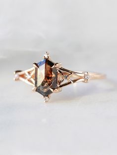 an engagement ring with two different colored stones