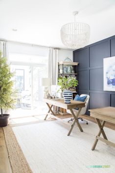 a living room filled with furniture and a chandelier hanging from the ceiling above