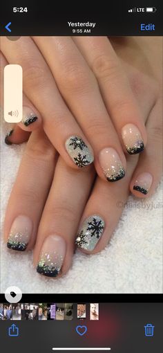 a woman's nails with black and white designs on them