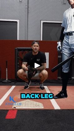 a man kneeling down in front of a baseball player with a bat on his knee