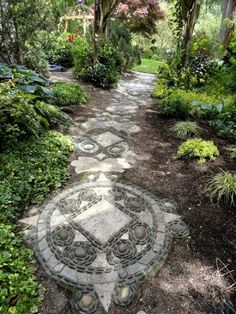 a stone path in the middle of a garden