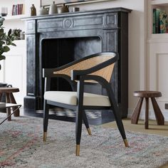 a chair sitting on top of a rug next to a fireplace