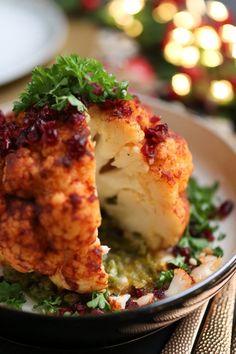 a plate with cauliflower on it and the words whole roasted vegan cauliflower