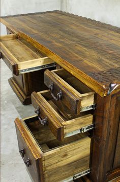 an old wooden desk with drawers on it