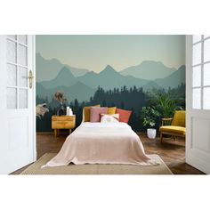 a bedroom with mountains and trees painted on the wall