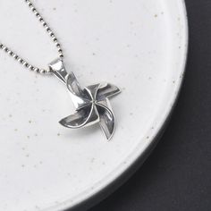 Sterling Silver Pinwheel Necklace Pendant, Pinwheel Charm Pendant, Wind Turbine Necklace Pendant, Wind Mill Pendant, Pinwheel Jewelry (Not Including Chain) Material: 925 Sterling Silver Weight: 7.3g * We guarantee 100% genuine Sterling Silver, If not we will refund your money. Care Instruction : 1. Avoid contact with all liquids and chemicals, such as perfume, sea water, mayonnaise, ammonia, chlorinated pool water, hair spray and sweat. Contact with these substances will increase the rate at whi Vintage Windmills, Water Hair, Wind Mill, Hair Spray, Sea Water, Pool Water, Necklace Box, Silver Box, Silver Jewelry Handmade