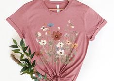 If you're looking for a special gift for your mom, sister, or best friend, consider a Wildflower Tshirt, Wildflower shirt for mom, or a Wild Flowers Shirt. These floral shirts are versatile and stylish, making them perfect for any occasion. Whether you choose a Floral Shirt or a Flower T-shirt, your loved one is sure to appreciate the thoughtful gesture. Product Description: ⇝ Bella and Canvas Brand Shirts ⇝ Unisex Adult Sizing ⇝ Rolled Sleeves in pictures are for styling purposes only ⇝ Props u Best Friend Flower, Wildflower Shirt, Floral Shirts, Gift For Best Friend, Brand Shirts, Rolled Sleeves, Gifts For Your Mom, Flower Shirt, Black Letter