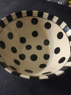 a black and white polka dot bowl sitting on top of a table