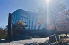 the sun shines brightly in front of an office building